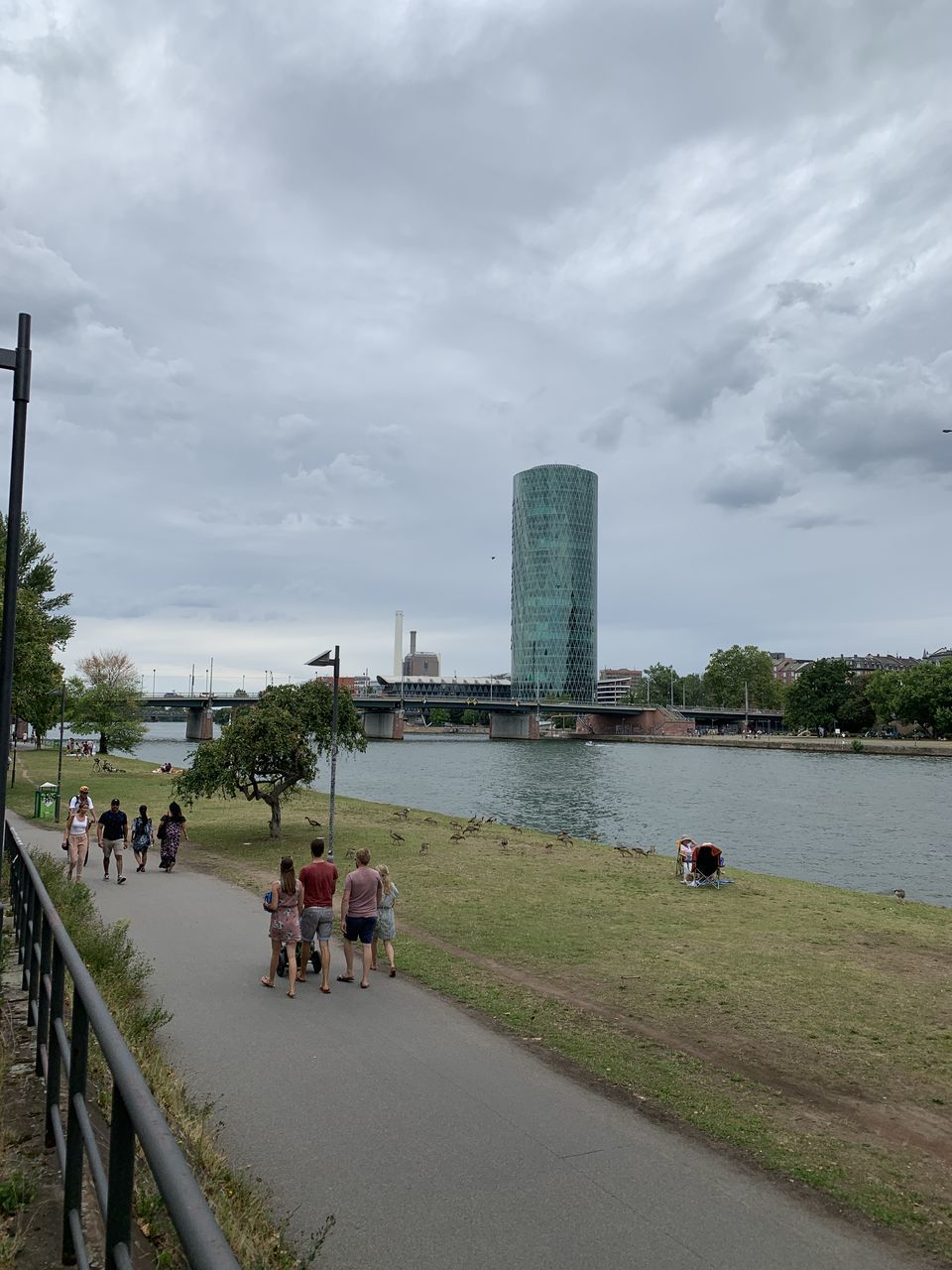 water, architecture, built structure, sky, group of people, building exterior, real people, nature, cloud - sky, river, men, city, day, transportation, people, travel destinations, plant, adult, outdoors, skyscraper, office building exterior