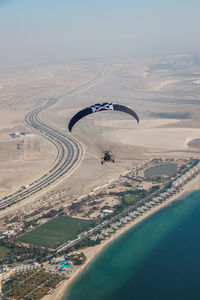 Aerial view of landscape with sea in background