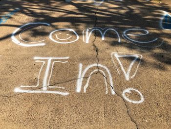 High angle view of text on graffiti in city