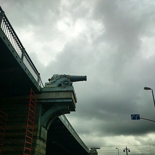 low angle view, architecture, built structure, sky, cloud - sky, cloudy, building exterior, cloud, overcast, weather, building, day, city, outdoors, no people, storm cloud, high section, architectural feature, modern, travel destinations