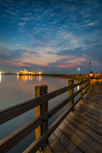 Pier over sea against sky during sunset