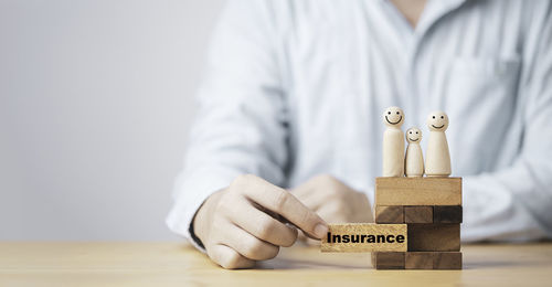 Midsection of man holding text on table