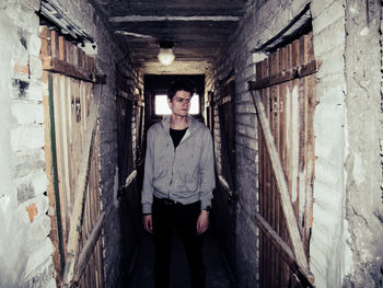 Man looking away standing in abandoned building