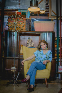 Portrait of woman sitting on chair