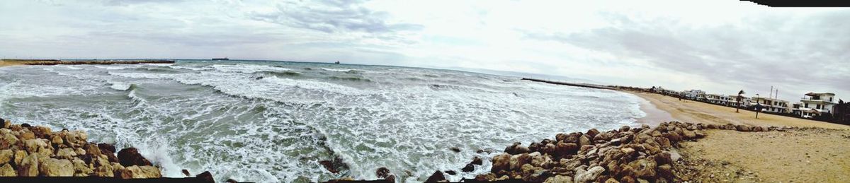 Scenic view of sea against cloudy sky