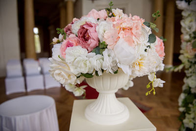 Close-up of flowers in urn on table