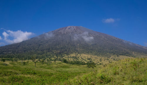 Scenic view of mount rinjani against blue sky