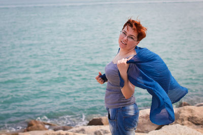 Full length of young woman standing on beach