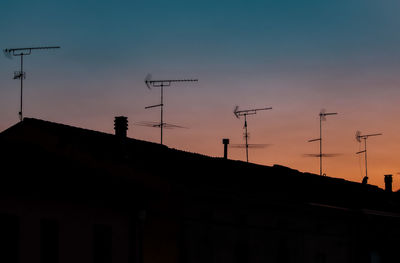 Low angle view of silhouette building against sky during sunset