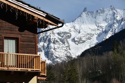 Wooden house against the snow mountain