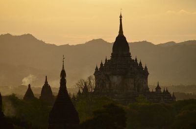 Silhouette of temple against sky during sunset