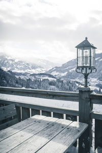 Built structure on snowcapped mountains against sky