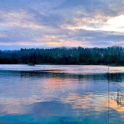 Scenic view of lake against cloudy sky