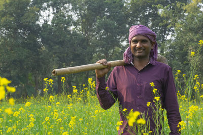 Portrait of a smiling young man standing on land