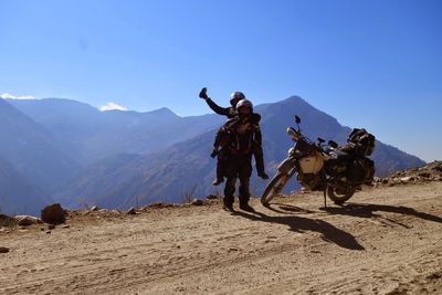 Man standing on mountain against clear sky