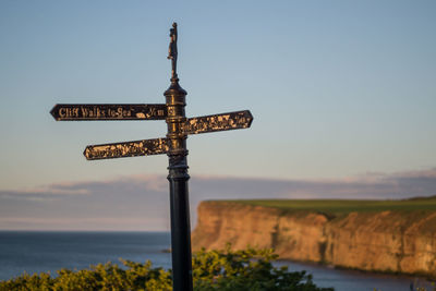 View of cross sign against sky