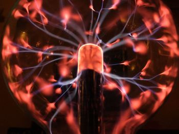 Close-up of man against illuminated light