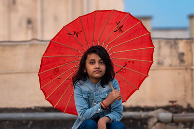 Portrait of woman holding umbrella