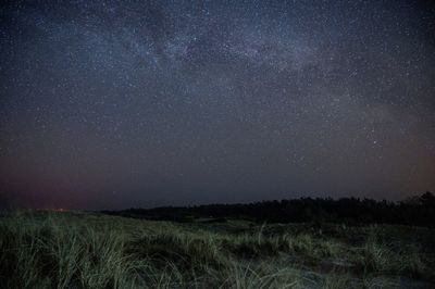 Scenic view of field against sky at night