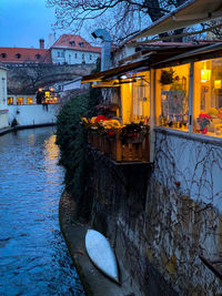 Reflection of building in canal in city during winter