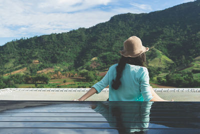 Rear view of woman looking at mountains