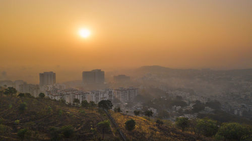 View of cityscape against sky during sunset