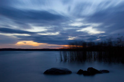 Scenic view of lake at sunset