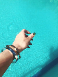 Midsection of man swimming in pool