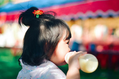 Close-up of girl blowing bubbles