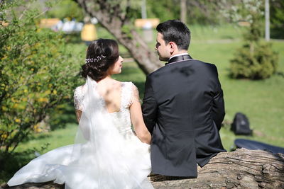 Rear view of couple holding hands