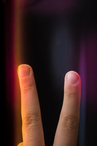 Close-up of human hand against black background