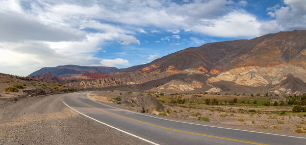 Road amidst mountains against sky