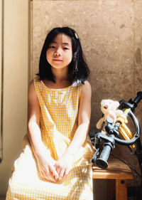 Portrait of young woman cute girl sitting on bed at home