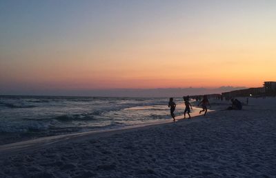 Scenic view of beach against sky during sunset