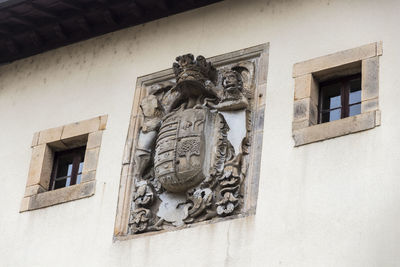 Low angle view of statue against building