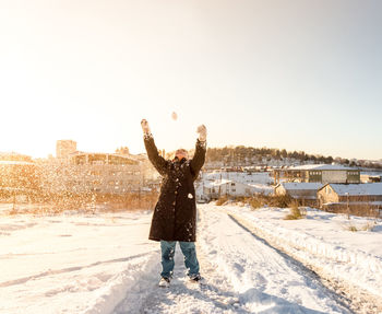 Full length of person standing on snow covered land