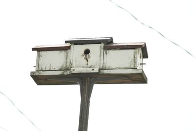 Low angle view of birdhouse against clear sky