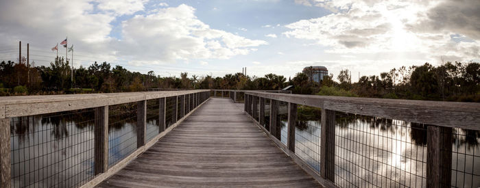 Bridge over calm sea against sky