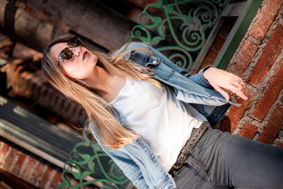 Young woman wearing casual clothing on the street. beautiful blond hair woman on the street.