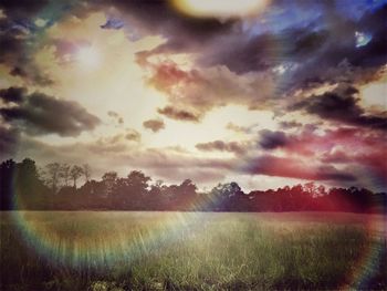 Scenic view of field against sky during sunset