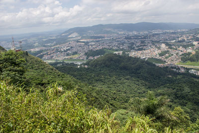 High angle view of cityscape against cloudy sky