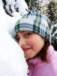 Portrait of young woman covering face