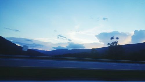 Scenic view of mountains against cloudy sky