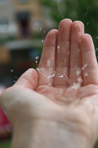 Close-up of hand with water