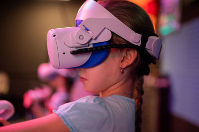 Vr game and virtual reality. kid girl gamer eight years old fun playing on futuristic video game