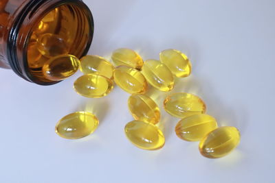 Directly above shot of glass bottles on white background