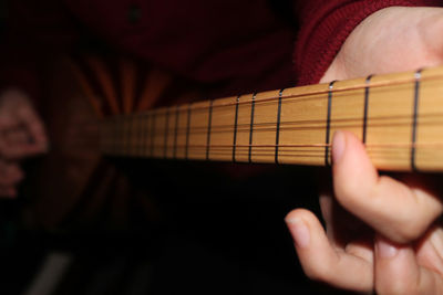 Midsection of person playing guitar