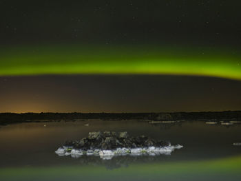 Scenic view of lake against sky at night