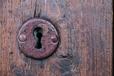 Full frame shot of old wooden door with keyhole