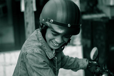 Smiling man sitting on motorcycle